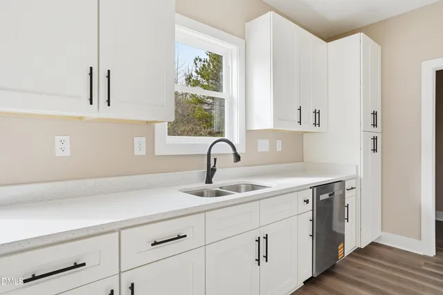 a kitchen with a sink and cabinets