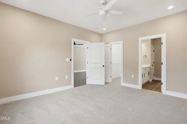 a view of a livingroom with a chandelier fan and closet area