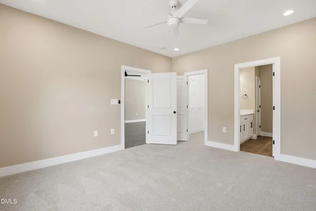 a view of a livingroom with a chandelier fan and closet area