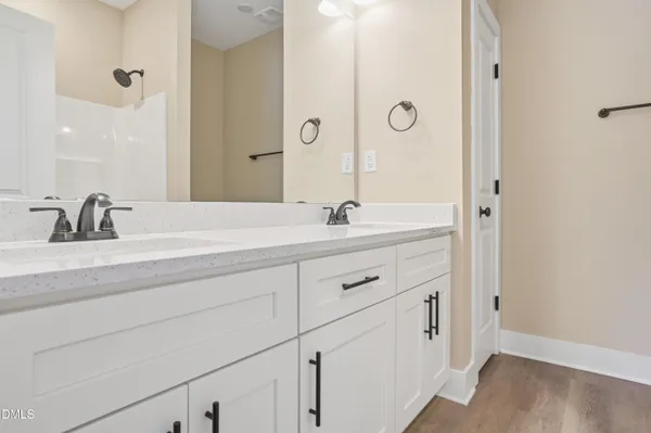 a bathroom with a double vanity sink and mirror