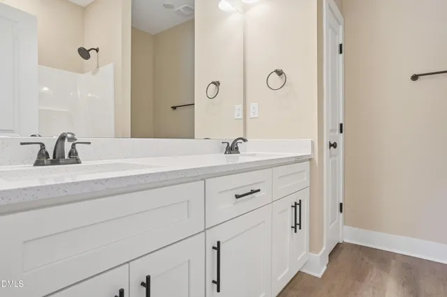 a bathroom with a double vanity sink and mirror