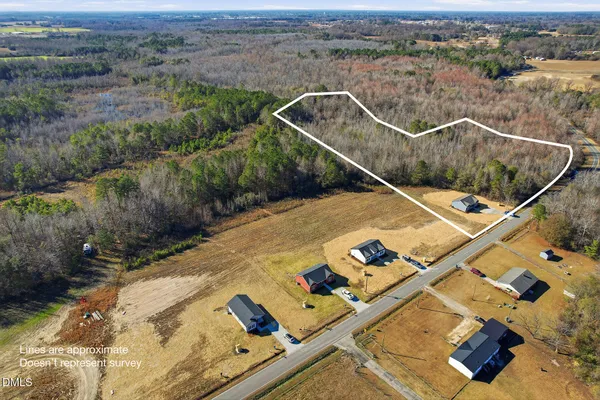 an aerial view of a house with a backyard