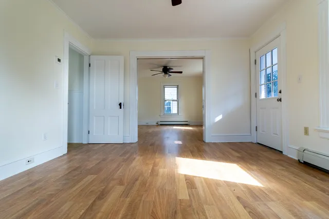 wooden floor in an empty room with a window