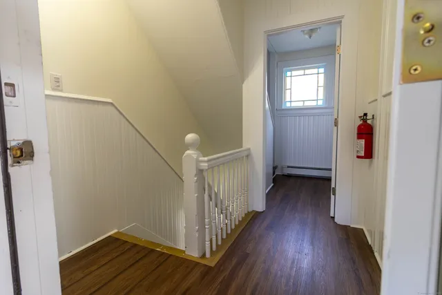 a view of a room with wooden floor and staircase