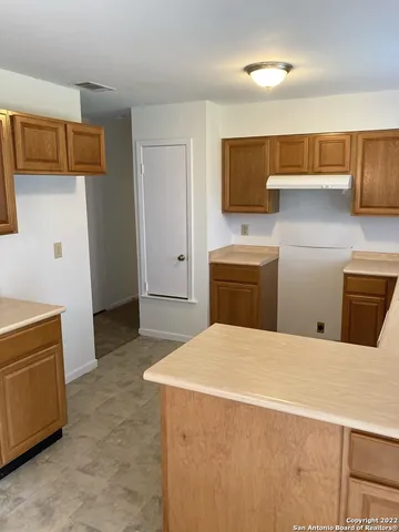 a bedroom with a bed and cabinets
