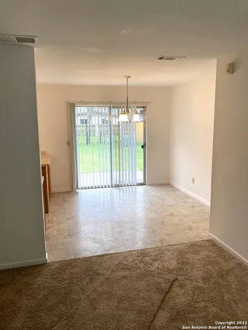 an empty room with floor to ceiling window and floor to ceiling window