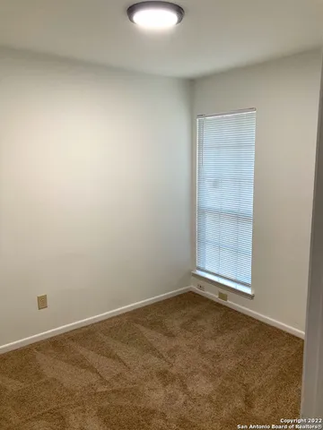 an empty room with a empty space and window