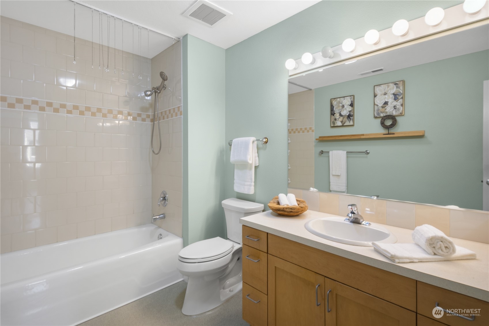 6713 35th Place South Seattle, WA 98118 - Photo 17 of 30 a bathroom with a granite countertop sink toilet and shower