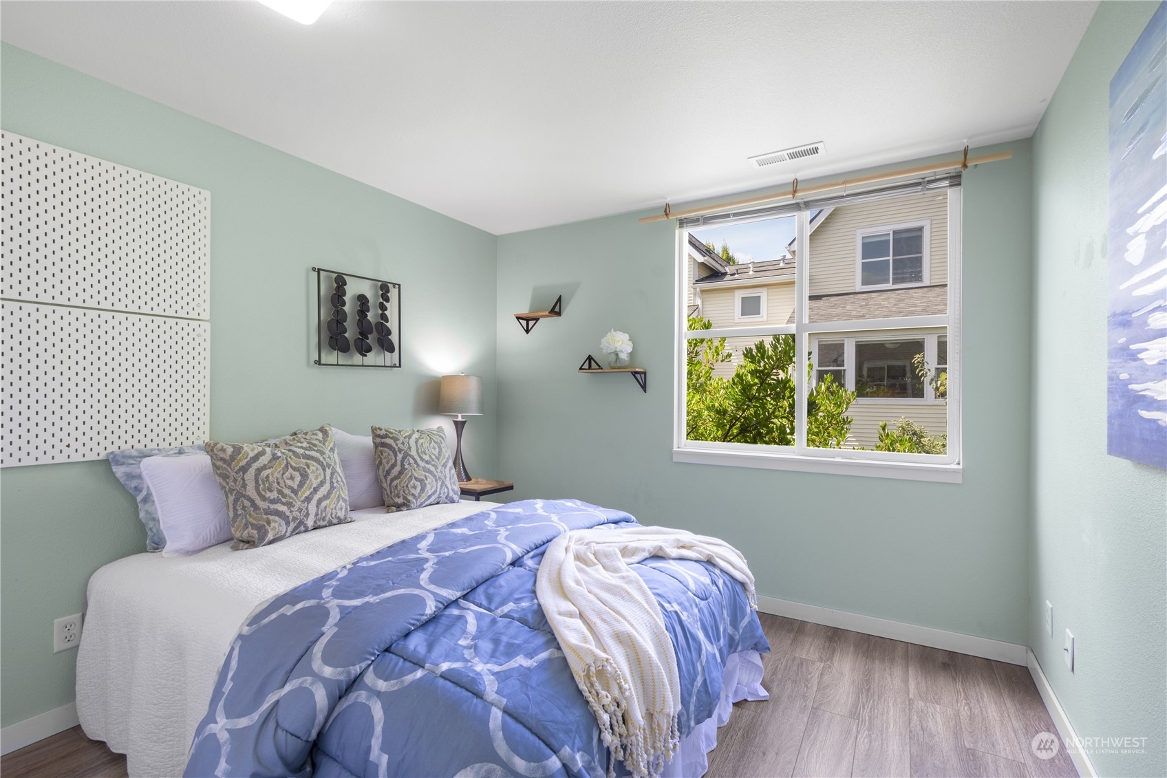 6713 35th Place South Seattle, WA 98118 - Photo 19 of 30 a bedroom with a bed and a window
