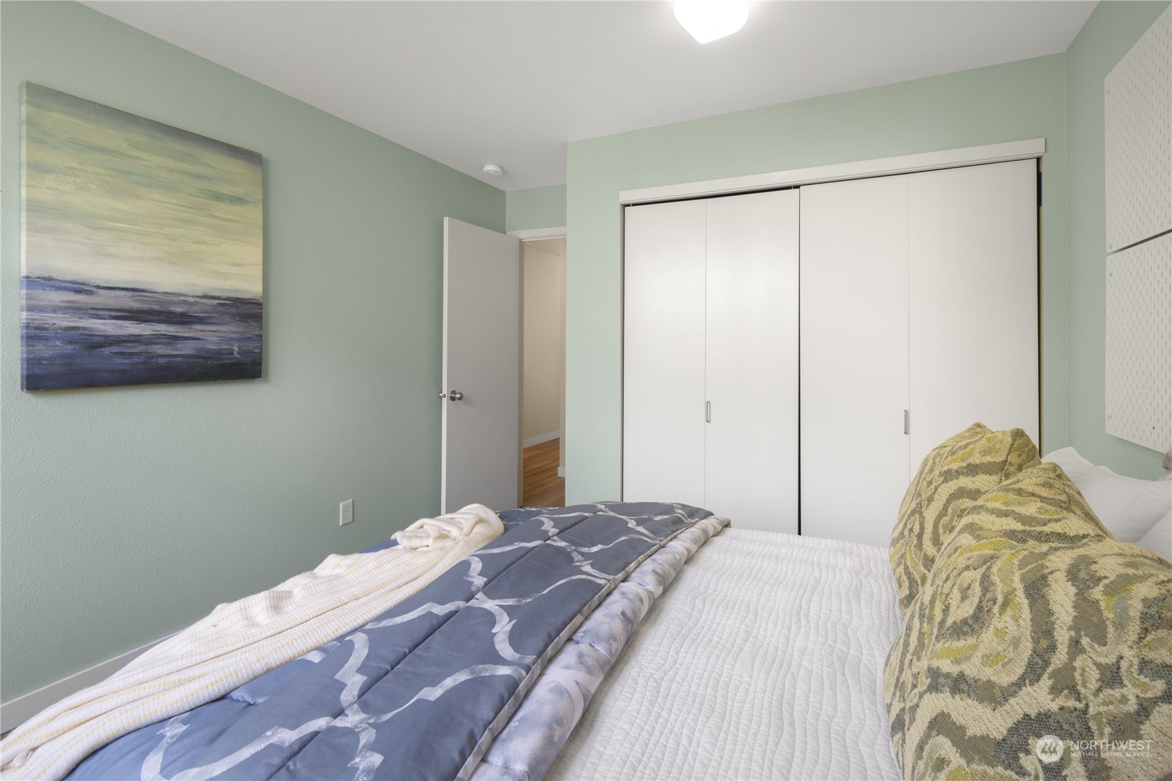 6713 35th Place South Seattle, WA 98118 - Photo 20 of 30 a bedroom with a bed and a painting on the wall