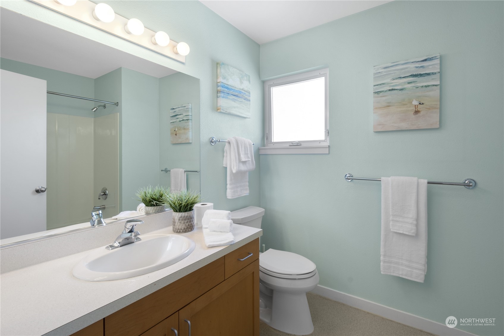 6713 35th Place South Seattle, WA 98118 - Photo 21 of 30 a bathroom with a toilet a sink and mirror