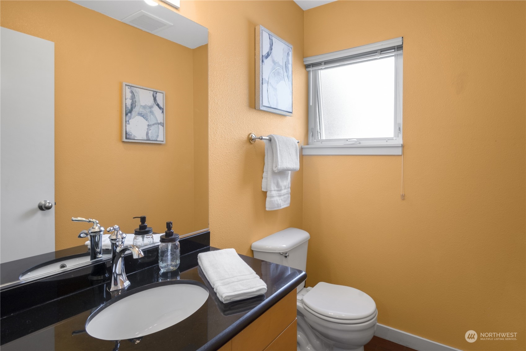 6713 35th Place South Seattle, WA 98118 - Photo 26 of 30 a bathroom with a toilet a sink and a mirror
