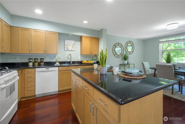 a kitchen with a stove cabinets a sink and a counter top space
