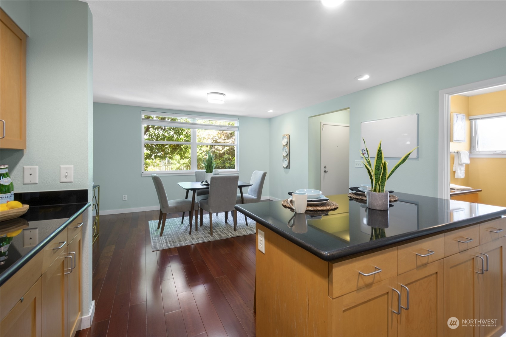 6713 35th Place South Seattle, WA 98118 - Photo 9 of 30 a kitchen with granite countertop a table and chairs in it