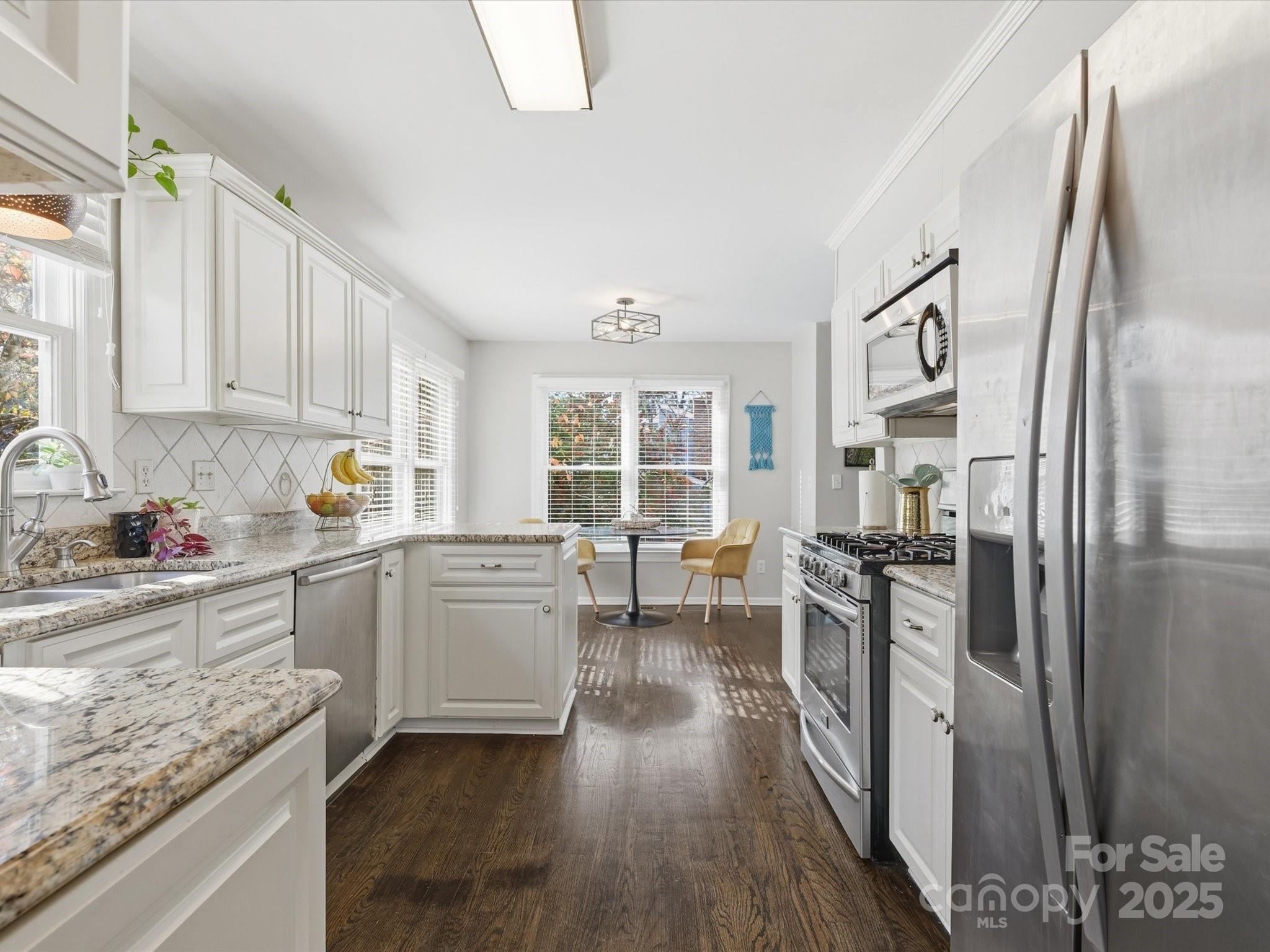 a kitchen with sink cabinets and wooden floor
