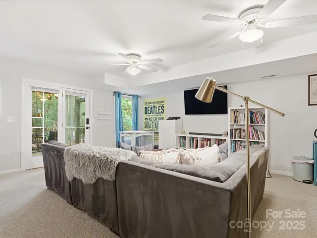 a bedroom with a bed table and a mirror