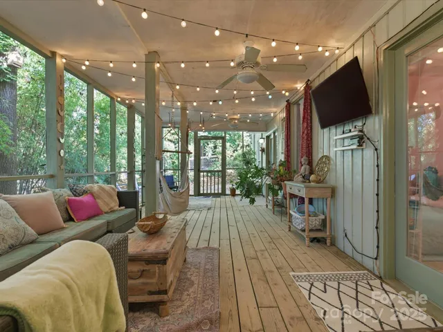 a living room with furniture a wooden floor and a chandelier
