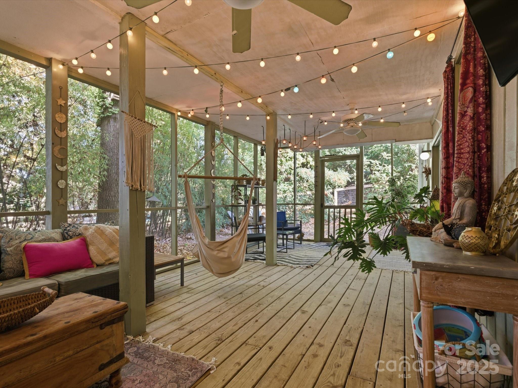 4002 Windward Drive Fort Mill, SC 29708 - Photo 23 of 41 a living room with furniture a flat screen tv and floor to ceiling window