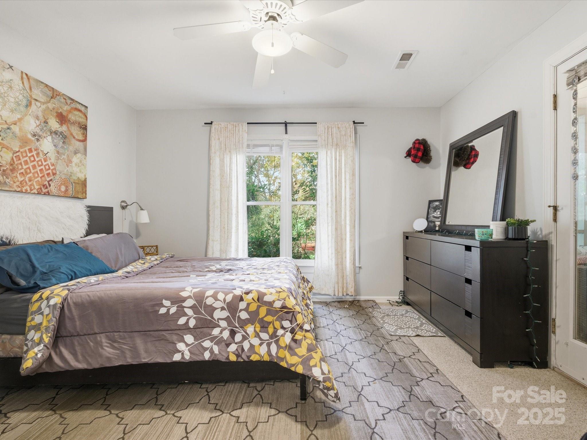 4002 Windward Drive Fort Mill, SC 29708 - Photo 26 of 41 a bedroom with a bed and a chandelier