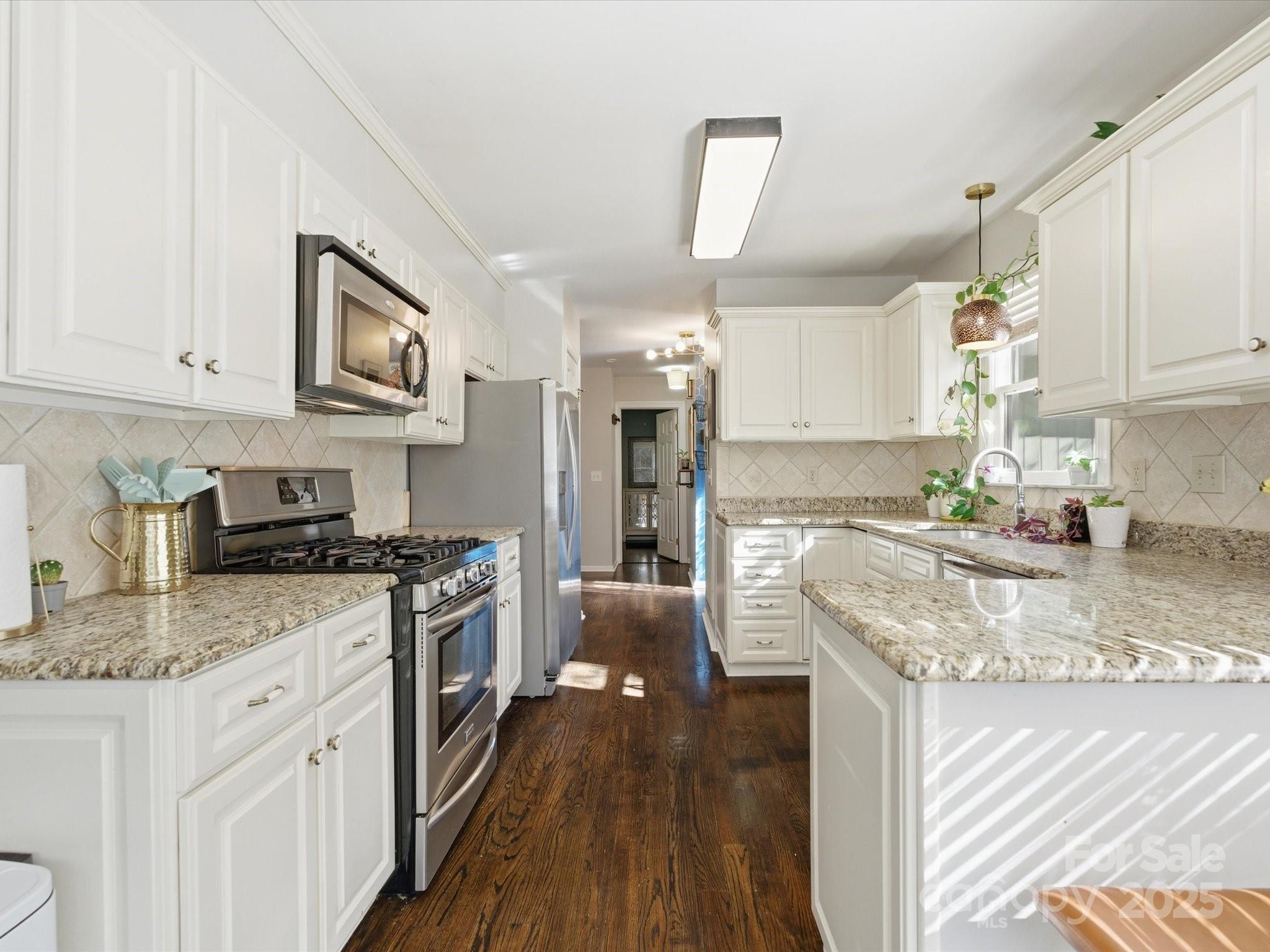 4002 Windward Drive Fort Mill, SC 29708 - Photo 4 of 41 a kitchen with stainless steel appliances granite countertop a stove top oven a sink dishwasher and a refrigerator with wooden floor