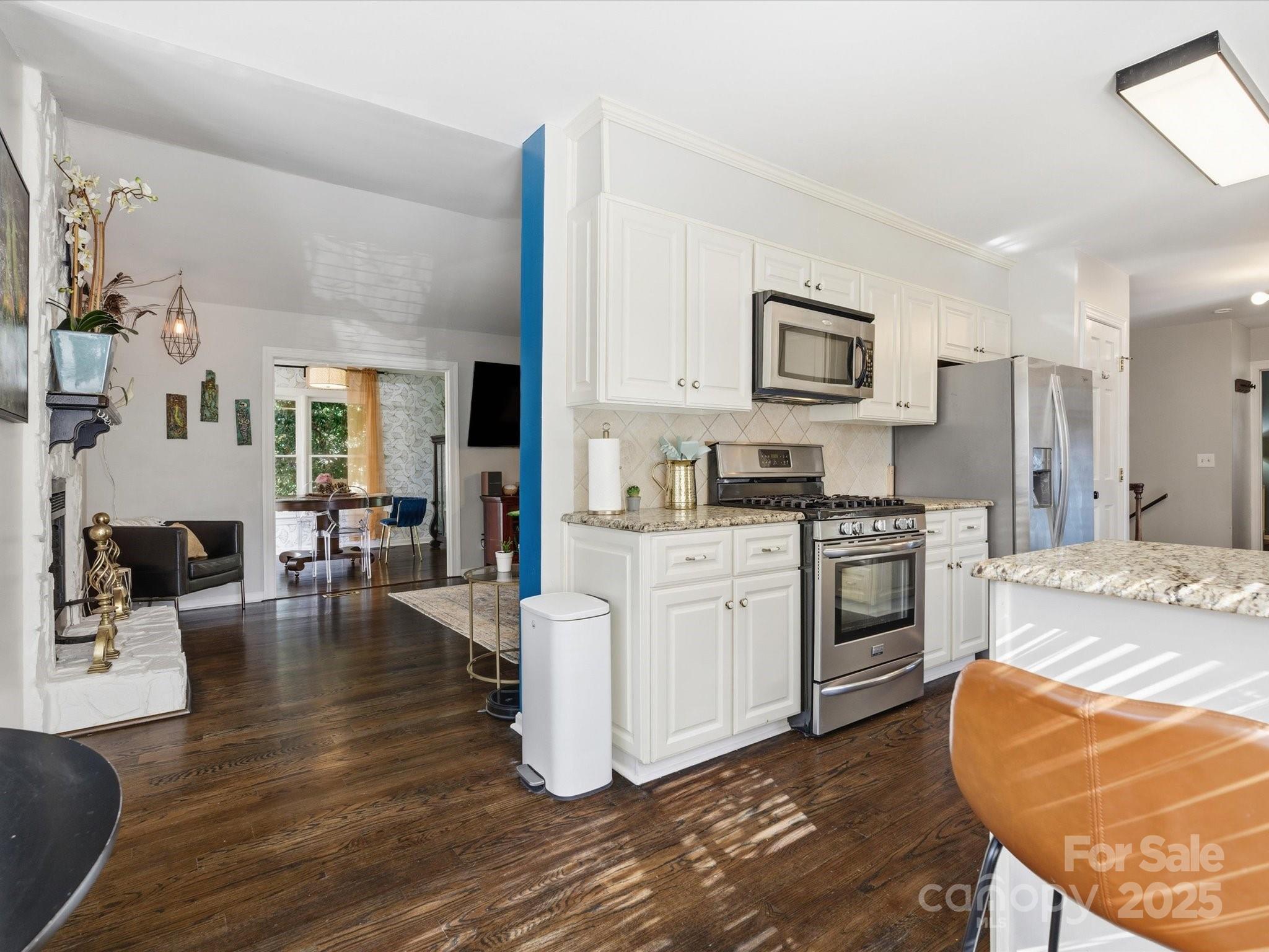 4002 Windward Drive Fort Mill, SC 29708 - Photo 5 of 41 a kitchen with granite countertop a stove a sink dishwasher and a refrigerator with white cabinets