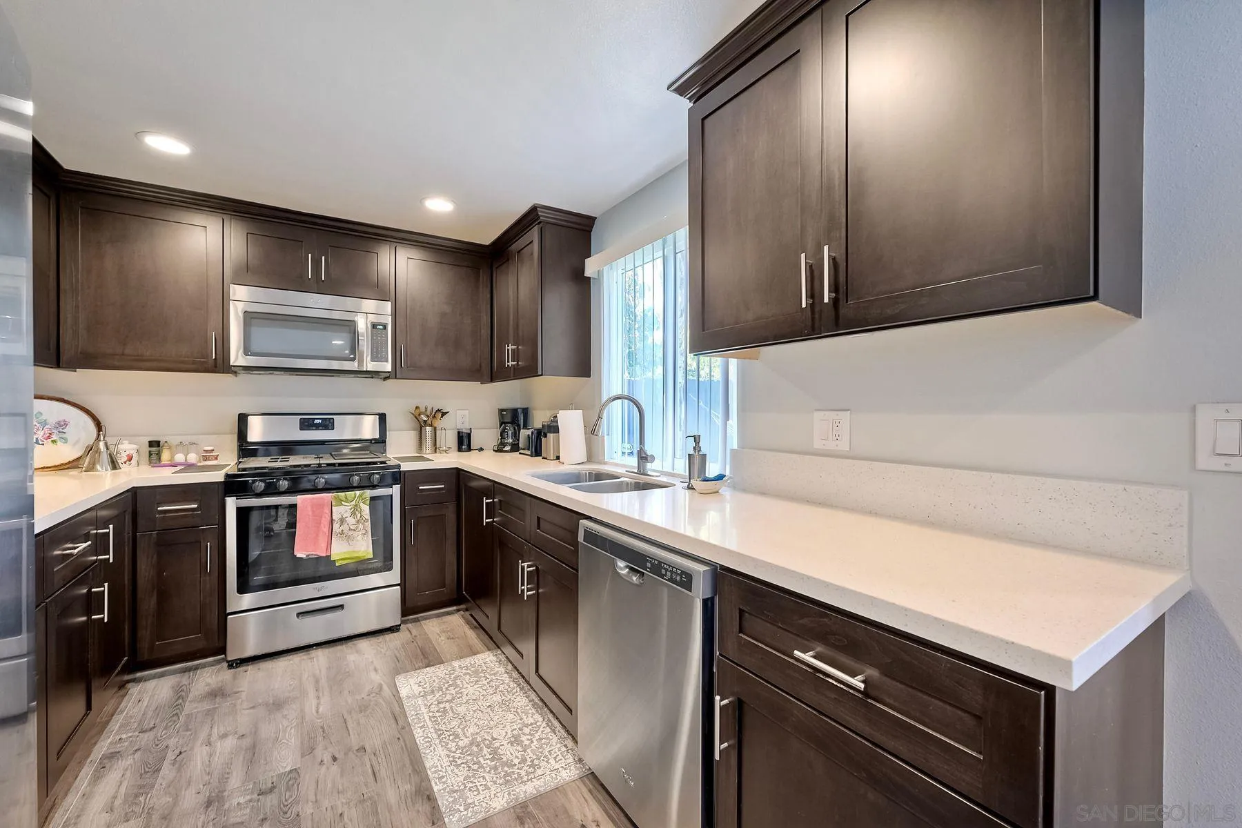 1122 Iris Avenue Imperial Beach, CA 91932 - Photo 12 of 35 a kitchen with stainless steel appliances granite countertop a sink and a stove