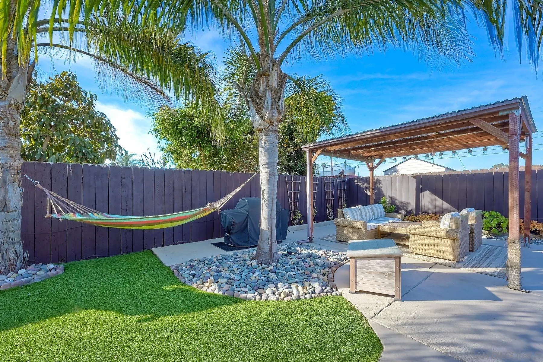 1122 Iris Avenue Imperial Beach, CA 91932 - Photo 5 of 35 a view of a backyard with plants and palm tree