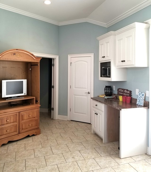 415 Wheeler Road Gray, GA 31032 - Photo 22 of 25 a kitchen with granite countertop a stove top oven and cabinets