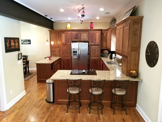 415 Wheeler Road Gray, GA 31032 - Photo 7 of 25 a kitchen with stainless steel appliances kitchen island granite countertop a table chairs and a refrigerator
