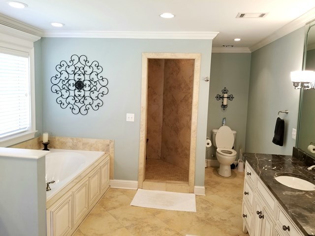 415 Wheeler Road Gray, GA 31032 - Photo 10 of 25 a bathroom with a granite countertop sink a toilet a mirror and shower