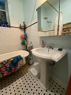 a bathroom with a sink toilet and a mirror