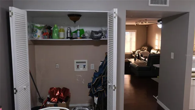 a view of a workspace with furniture and a window