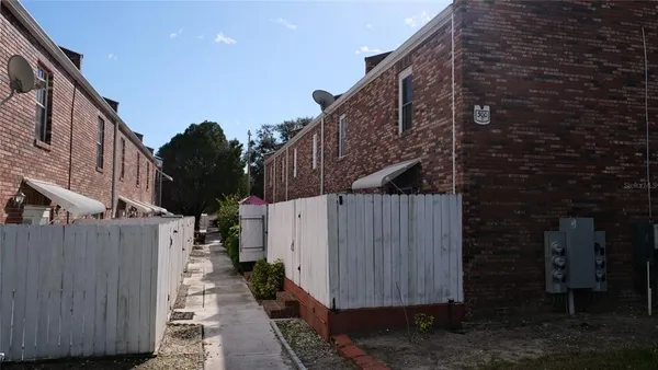 a view of a brick house with a large windows