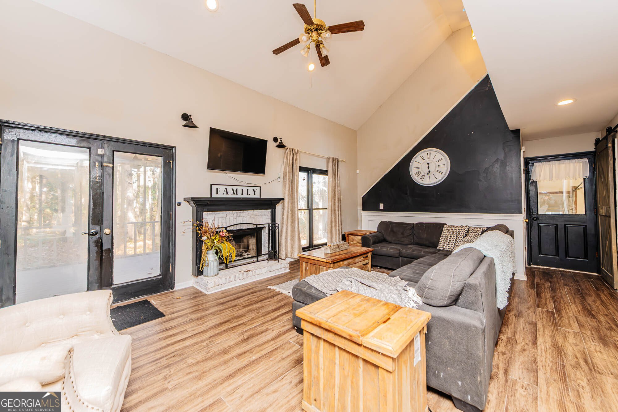 5341 Northside Drive Macon, GA 31210 - Photo 13 of 43 a living room with furniture a flat screen tv and a fireplace