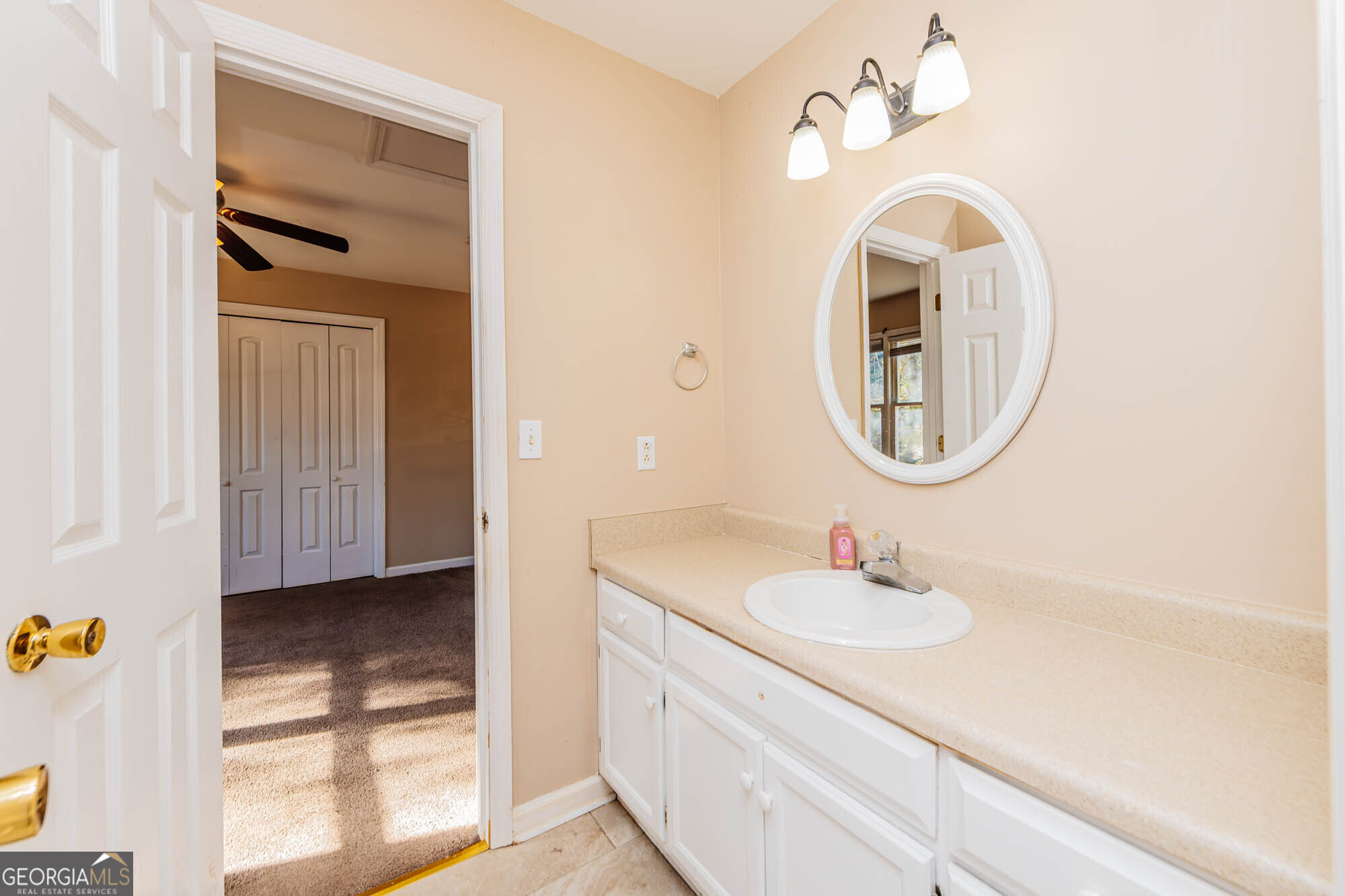 5341 Northside Drive Macon, GA 31210 - Photo 23 of 43 a bathroom with a sink a vanity and a mirror
