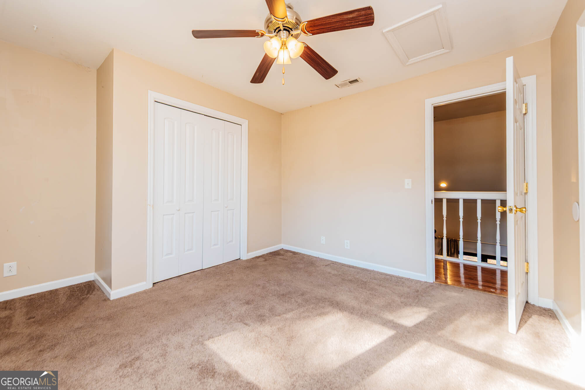 5341 Northside Drive Macon, GA 31210 - Photo 28 of 43 an empty room with stairs and a chandelier fan
