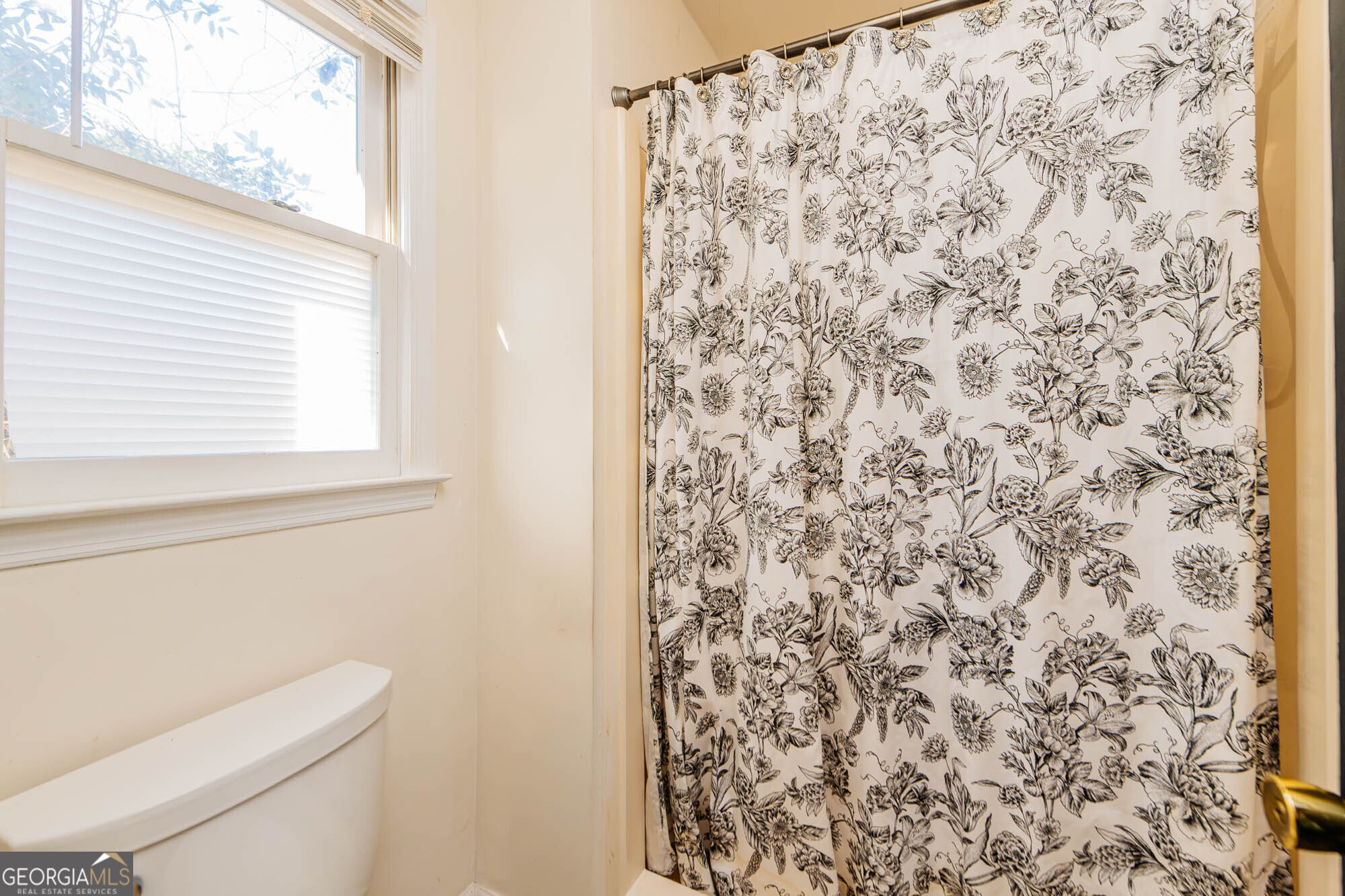 5341 Northside Drive Macon, GA 31210 - Photo 29 of 43 a bathroom with a toilet and a shower curtain