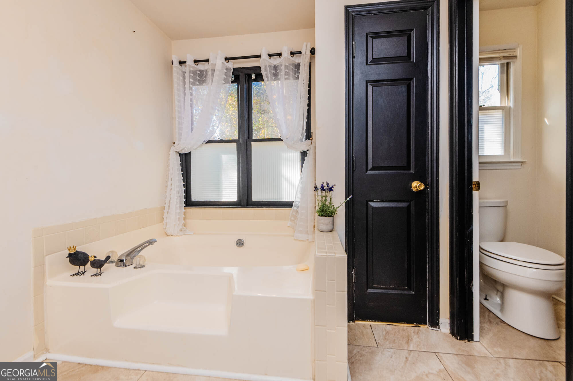 5341 Northside Drive Macon, GA 31210 - Photo 31 of 43 a bathroom with a bathtub and a toilet