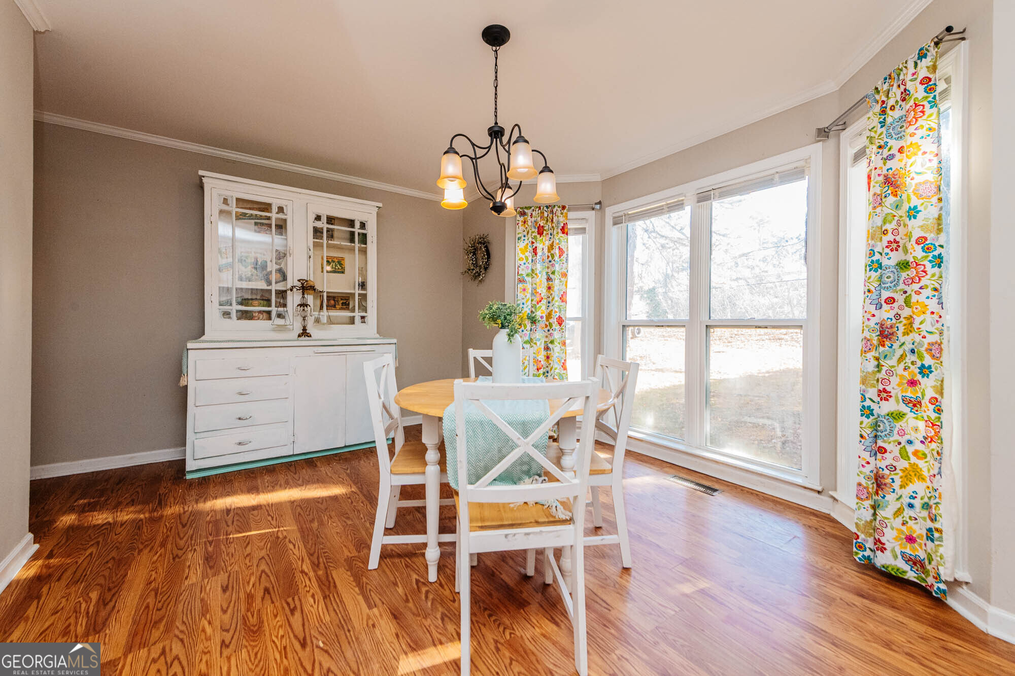 5341 Northside Drive Macon, GA 31210 - Photo 7 of 43 a dining room with furniture a chandelier and wooden floor