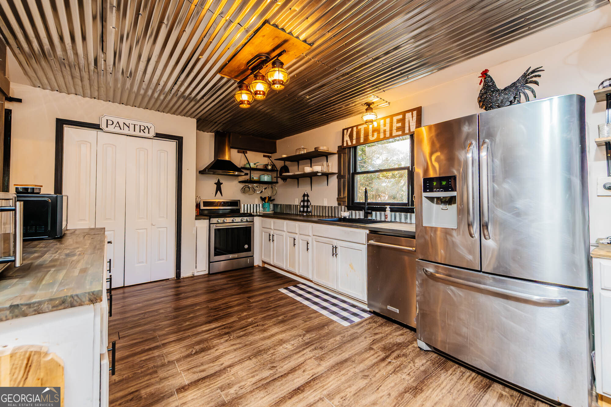 5341 Northside Drive Macon, GA 31210 - Photo 8 of 43 a kitchen with stainless steel appliances a refrigerator and wooden floor