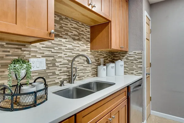 a kitchen with a sink and a potted plant