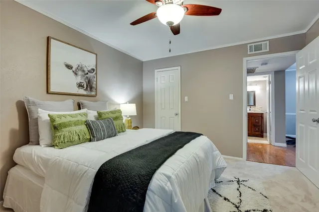 a bedroom with a large bed and a chandelier