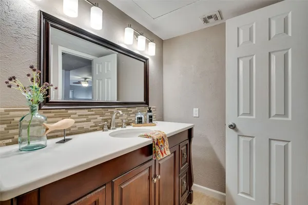 a bathroom with a double vanity sink and a mirror