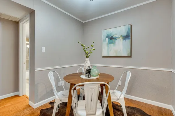 a dining room with furniture and wooden floor