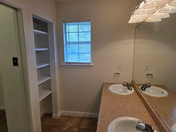 a bathroom with a sink toilet and a mirror