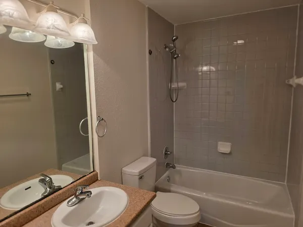 a bathroom with a sink toilet tub and shower