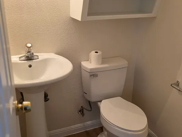 a white toilet sitting next to a bathroom sink
