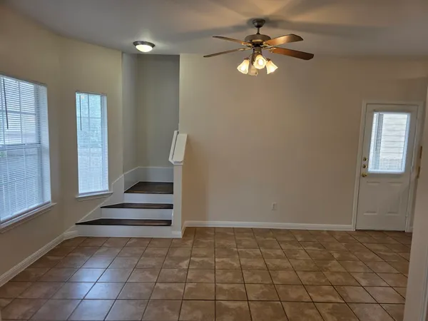 a view of room with a ceiling fan and window