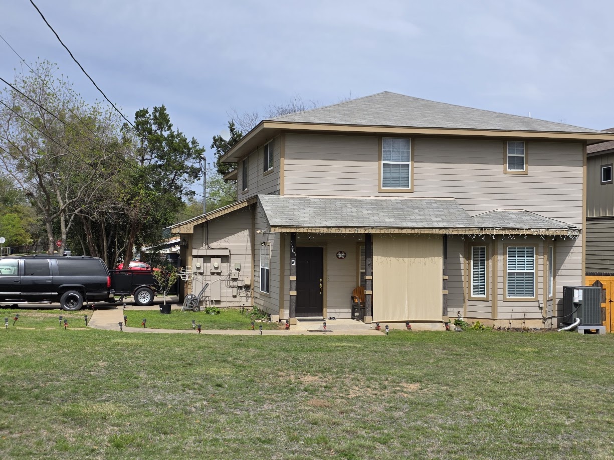 3308 Elija Street, Unit B Austin, TX 78745 - Photo 8 of 20 View of front of house featuring a front lawn, roof with shingles, and covered porch