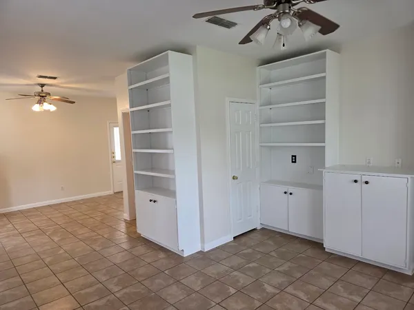 a view of an empty room with a fan